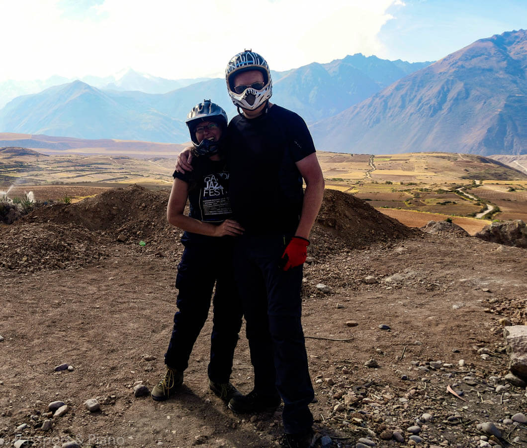 An image of me and my partner with crash helmets on. Taken whilst cycling between Moray and Maras in Peru.