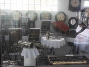 An image of one of the random displays at the Jeath Museum. The image shows some clocks and musical instruments.