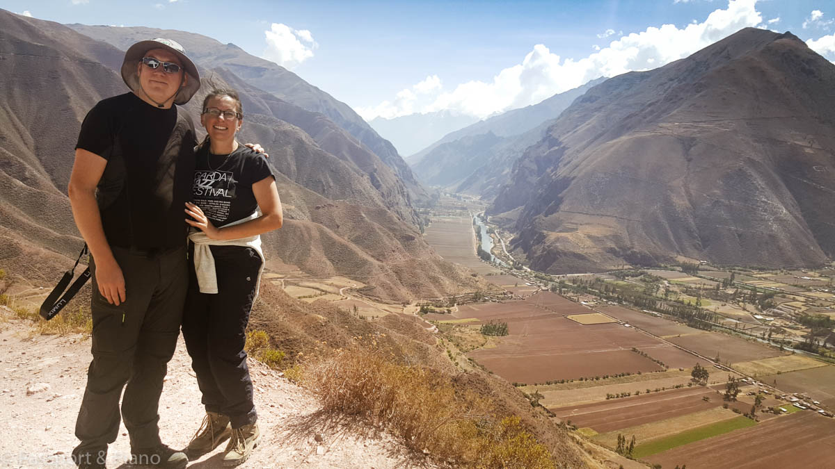 An image of me in Ollantaytambo, Peru wearing hiking boots with a mountain view.