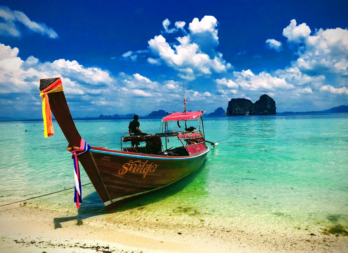 An image of a boat and the turquoise sea at Koh Ngai,one of the best places to visit in Thailand