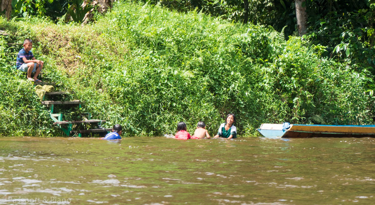 An image of children playing in the river on route to clearwater caves