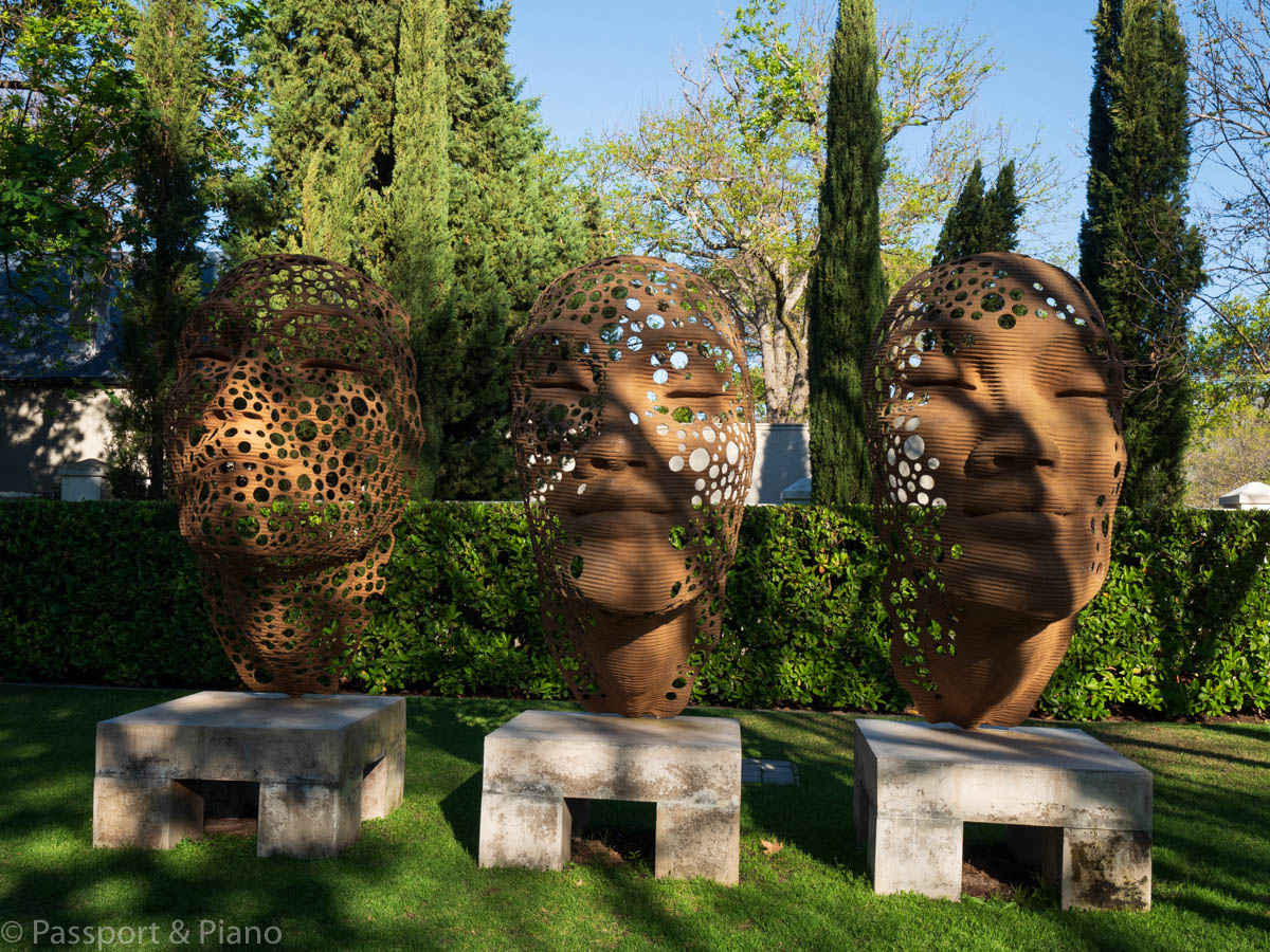 An image of 3 bronze head statues at Grand Provence