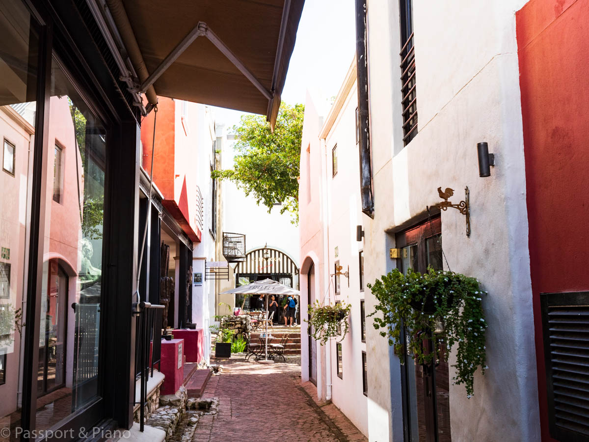 An image of one of the beautiful hidden alleyways that leads to a courtyard with a cafe in Franschhoek