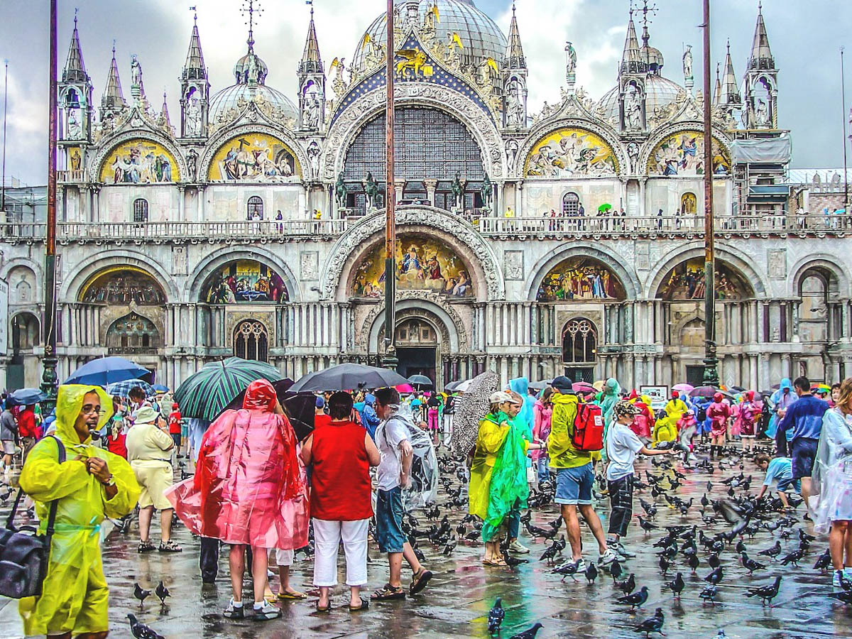 An image of lots of people wearing rain ponchos in Venice