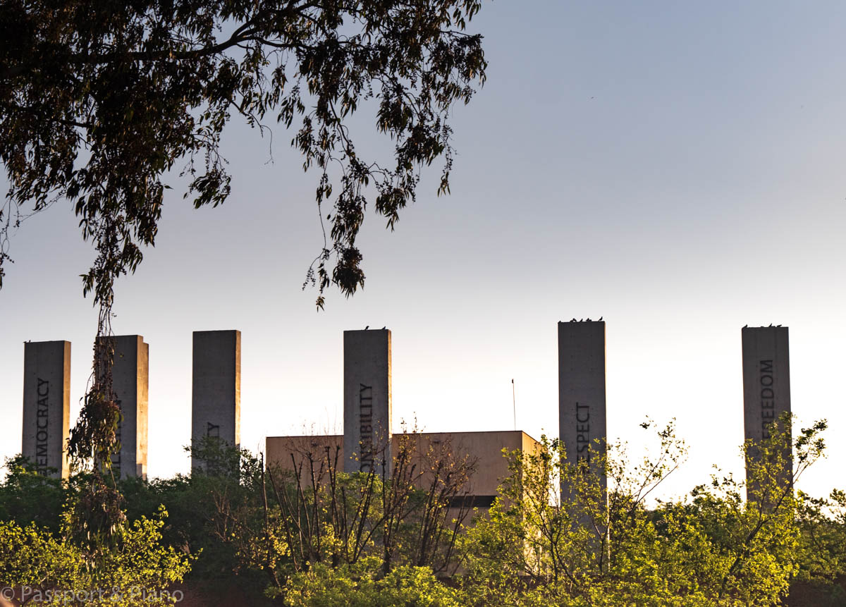 An image of the pillars that state the main areas of the South African Constitution outside the Apartheid Museum
