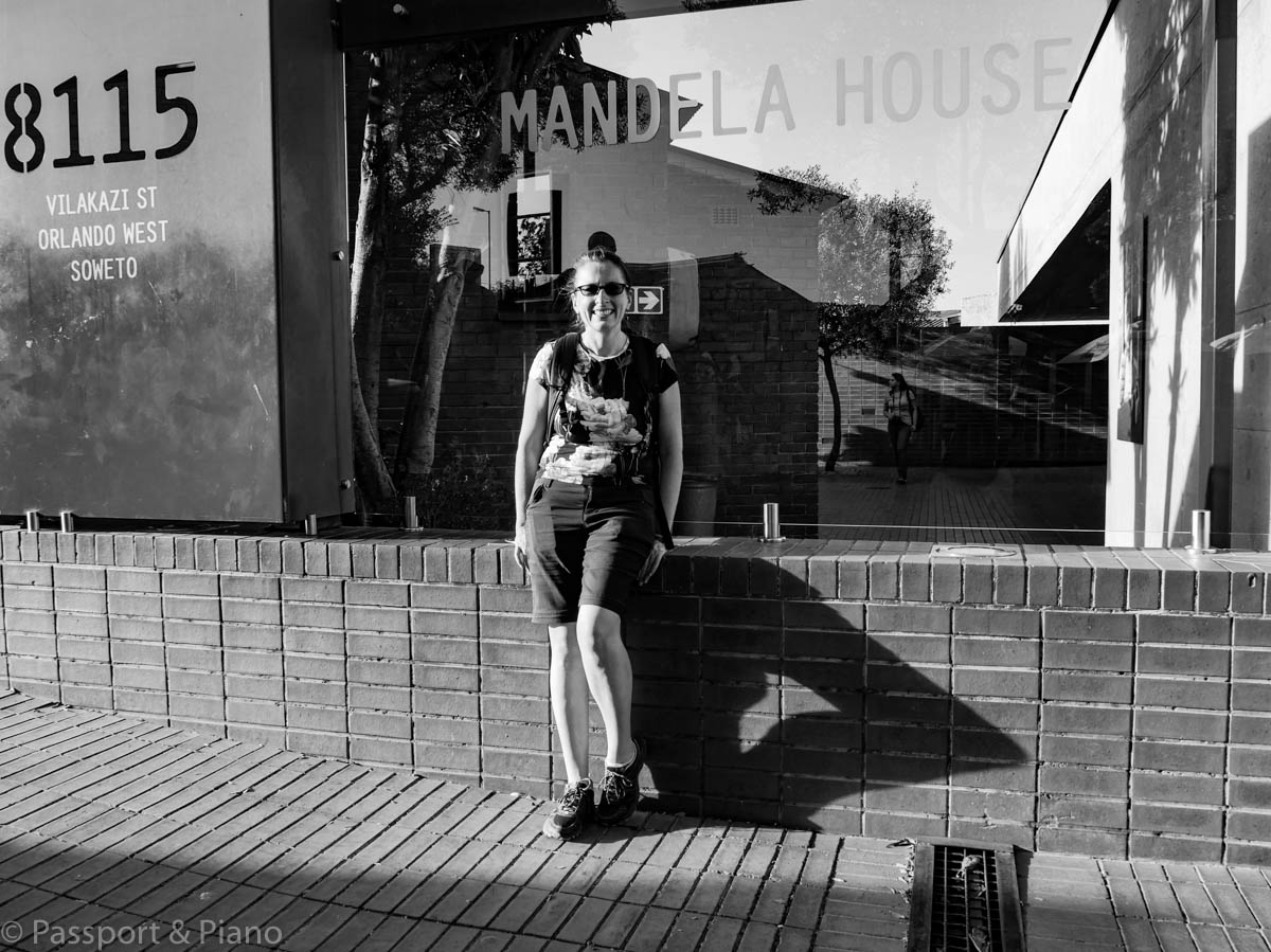 An image of myself (Fiona from Passport and Piano) outside Nelson Mandela's house on visit Johannesburg