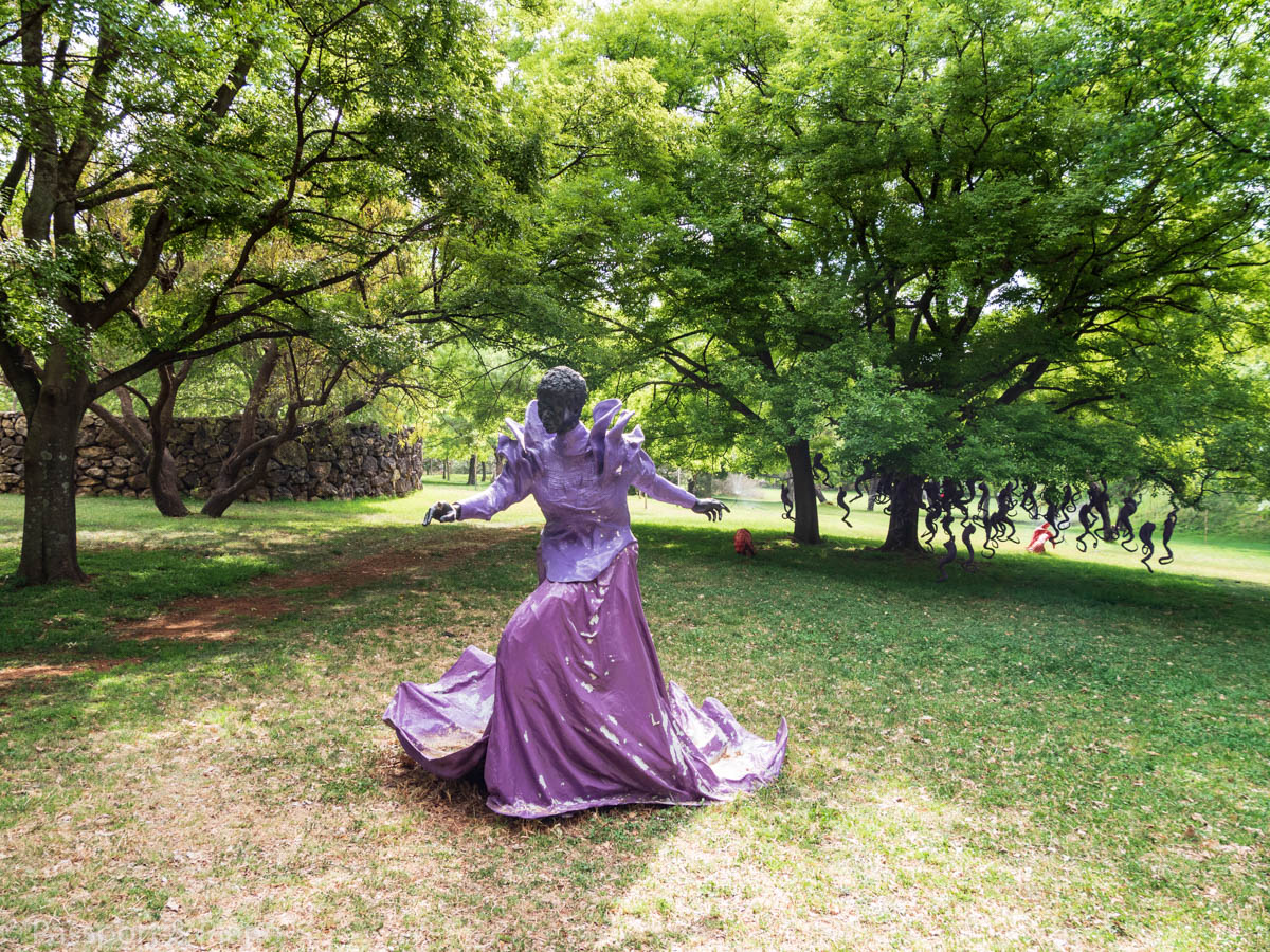 An image of a sculpture of a lady dressed in Purple