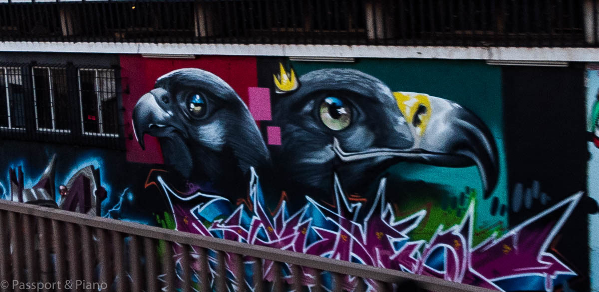 An image of some street art that depicts two birds 