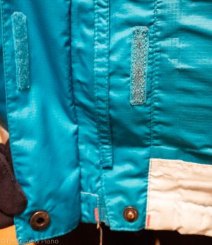 An image of the outer flap that covers the zip on a scandinavian jacket