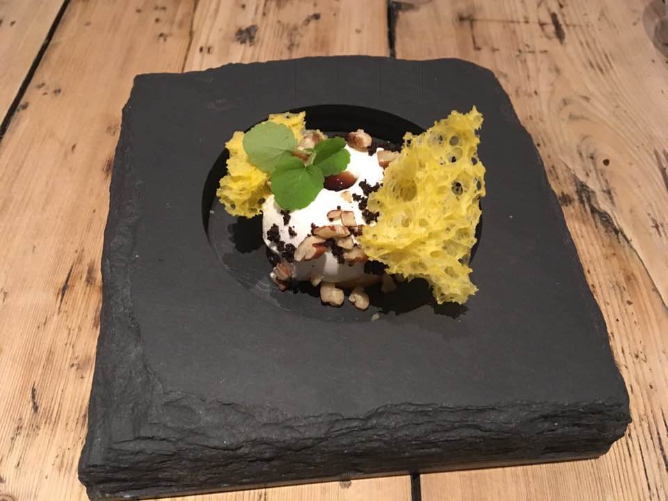 An image of a desert served on a black slate at the Forest Side Michelin Starred restaurant 